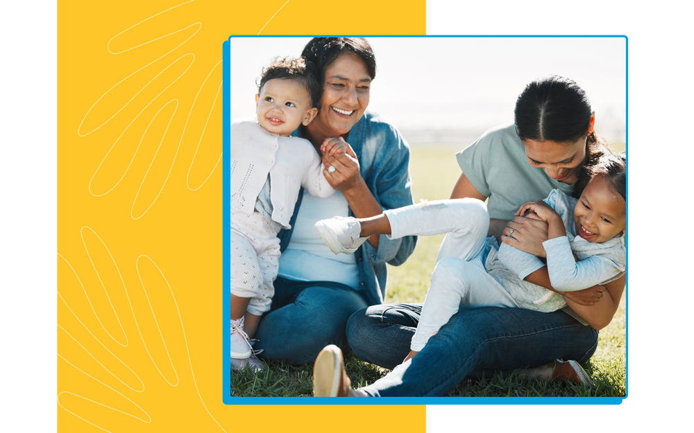 Smiling baby, toddler, mom and grandmom on grass